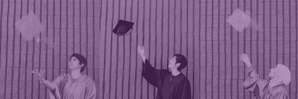 Graduating students celebrate their achievement by throwing graduation caps in the air during a commencement celebration.